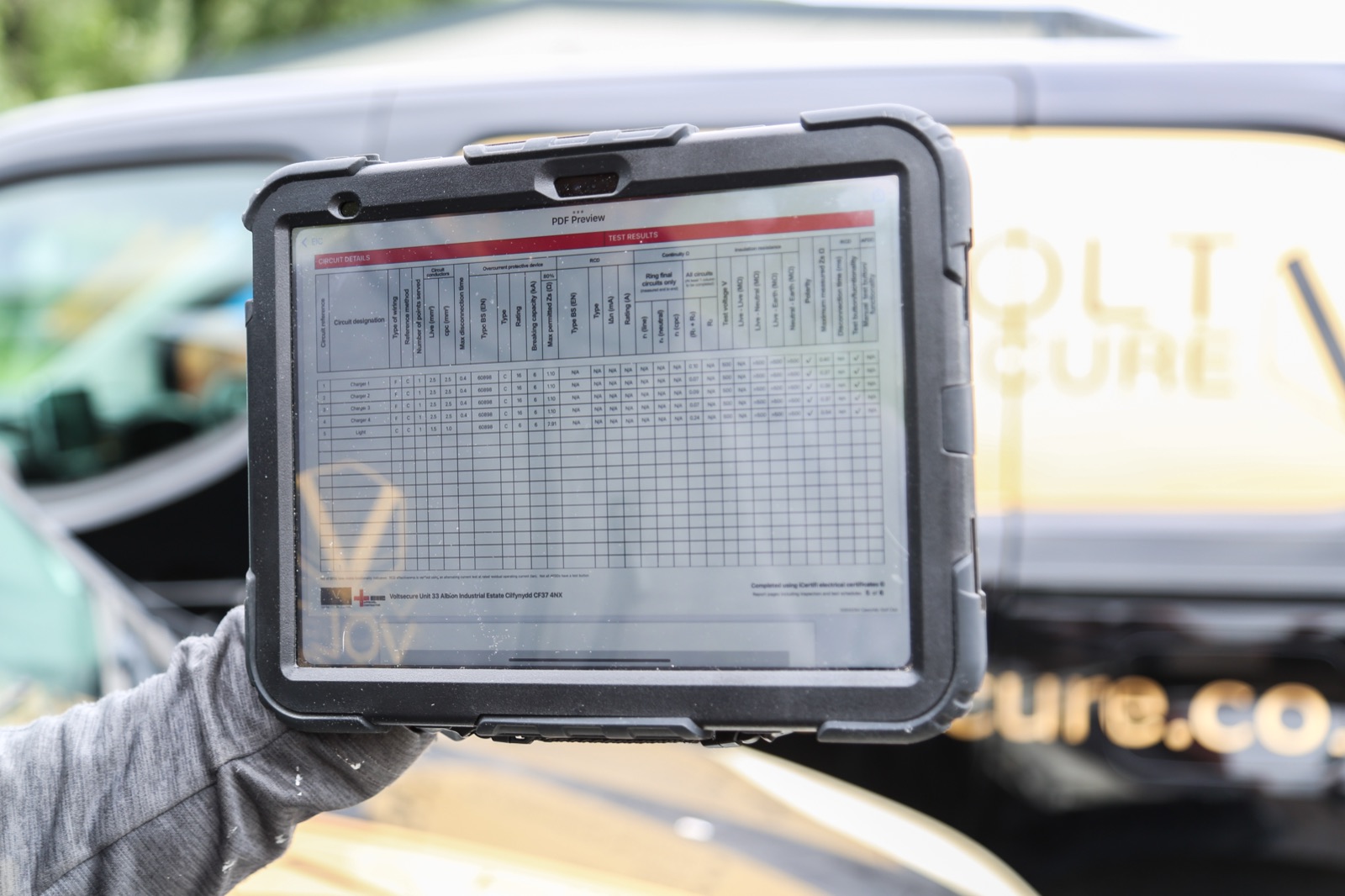 Service-record paperwork on a tablet - VoltSecure compliance documentation