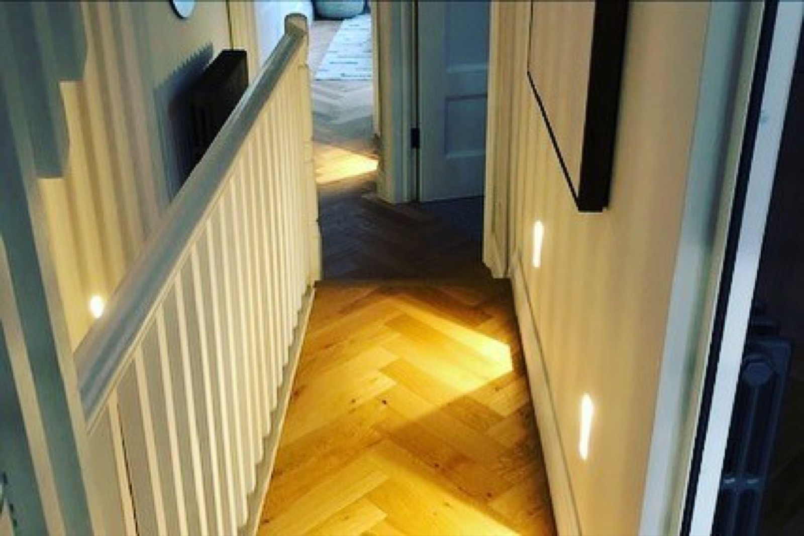 Prestigious London apartment in Balham - bespoke second fix electrical installation supporting premium herringbone parquet hallway and panelled interior