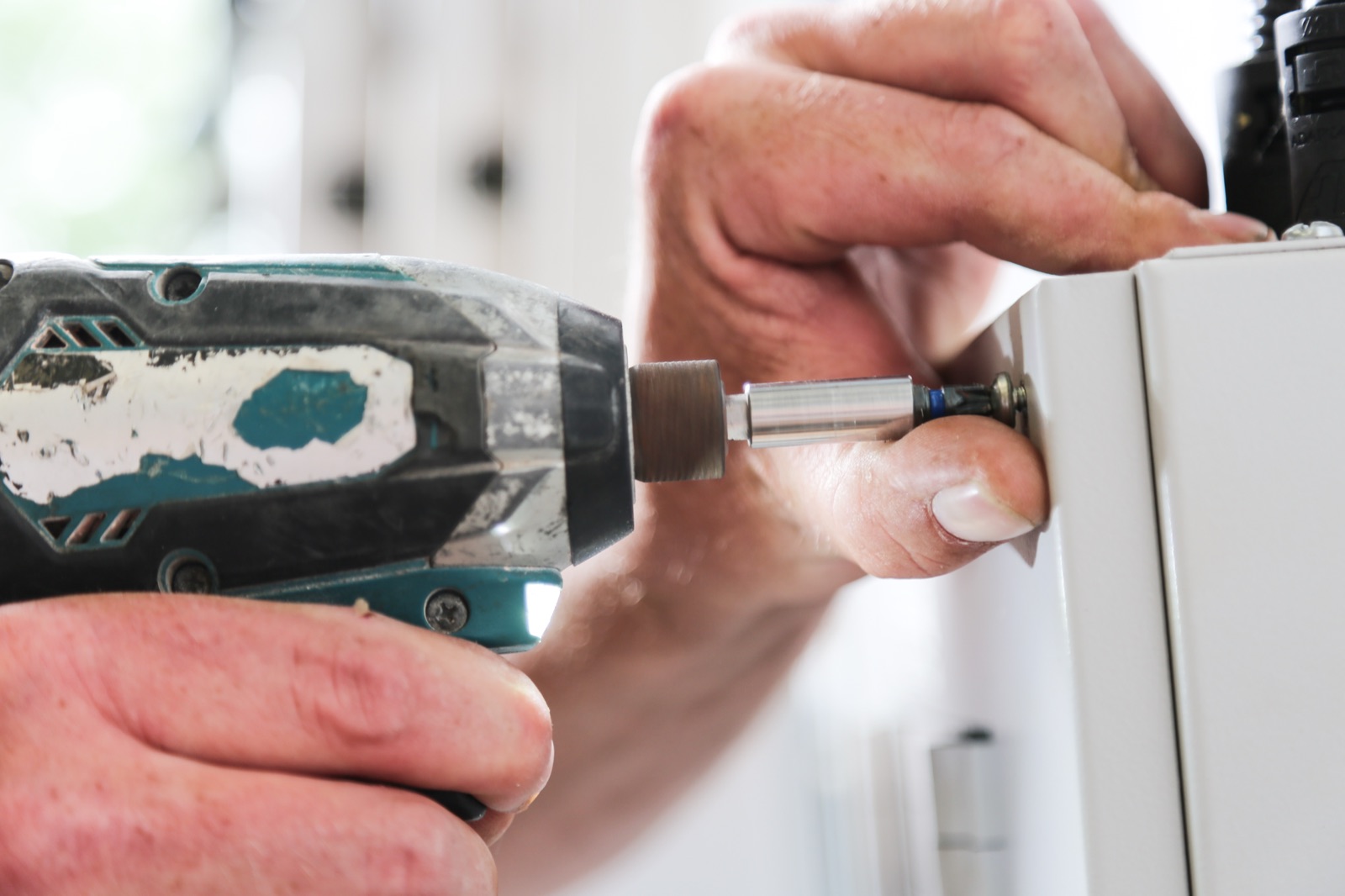 Engineer installing wall-mounted access control device