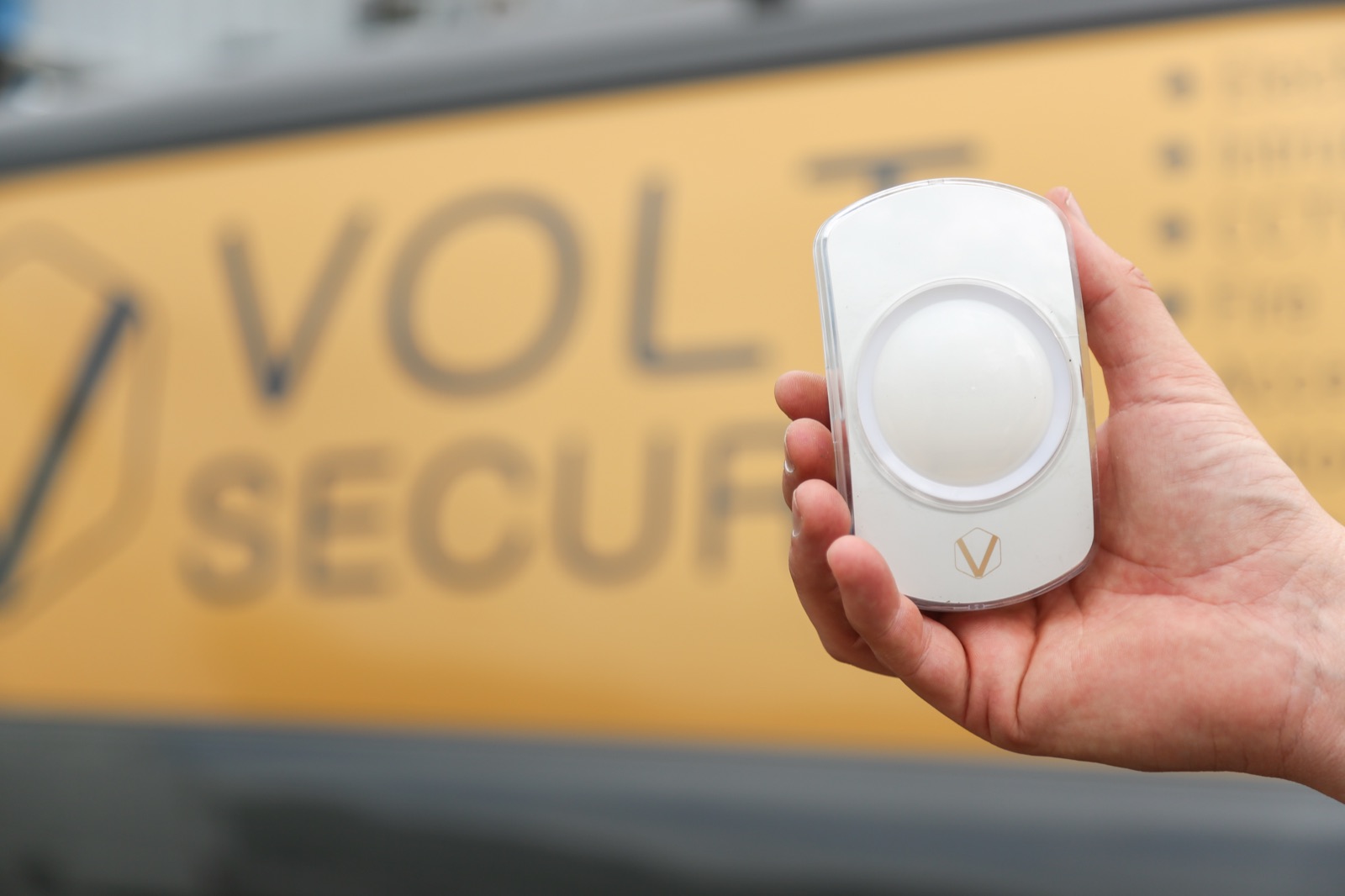 Fire-detection device held in front of a VoltSecure van